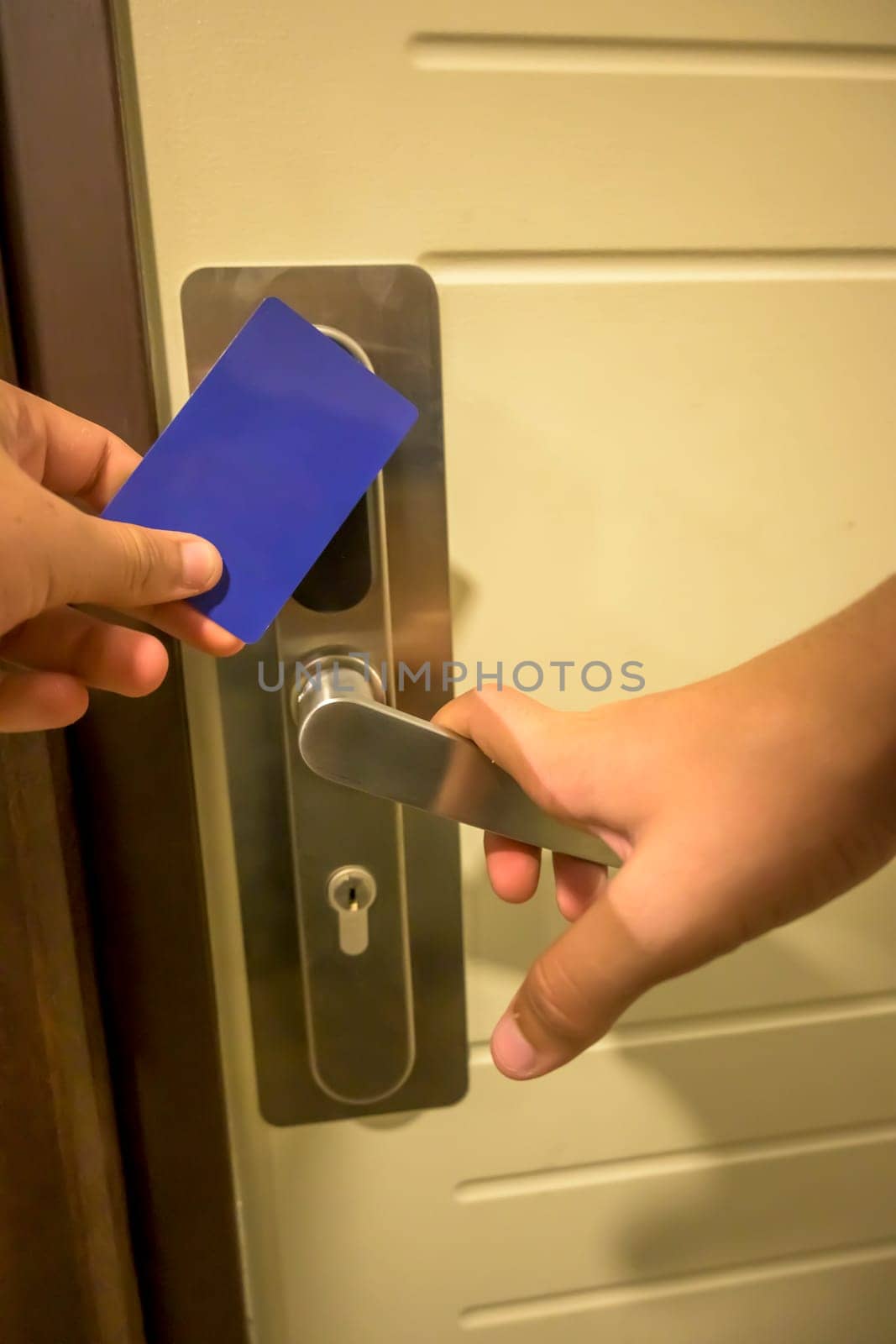 A hand inserting a blue card key into a modern hotel door lock, key electronic lock, hotel room, holidays in mallorca, spain,