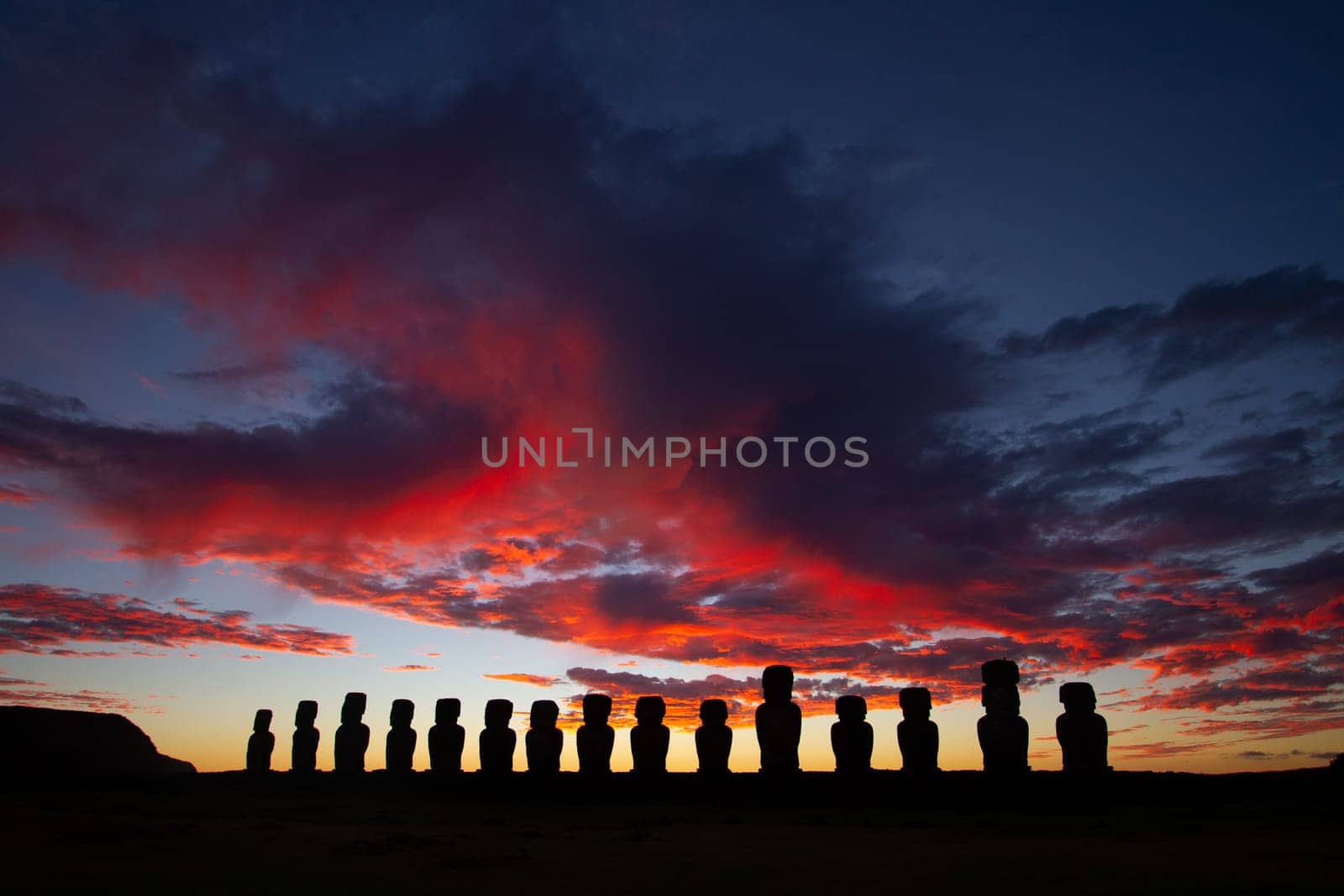 Dramatic colorful sunrise over Moai stone sculptures at Ahu Tongariki, Easter island, Chile