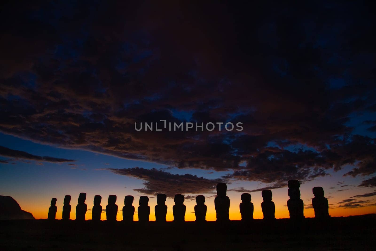 Dramatic colorful sunrise over Moai stone sculptures at Ahu Tongariki, Easter island, Chile