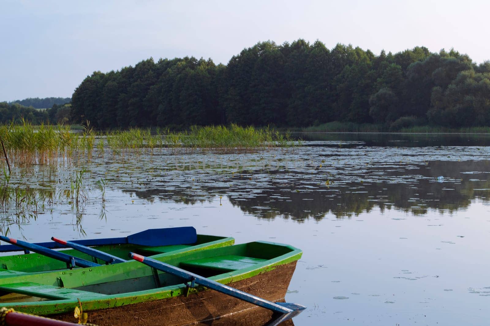landscape with two wooden boats on the river in Belarus