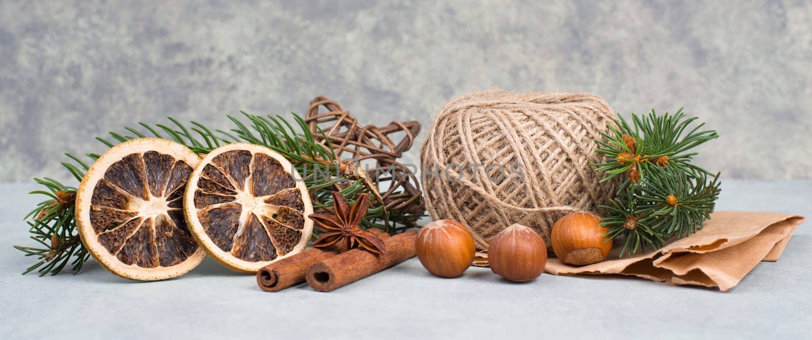 Christmas items like dried oranges, hazelnuts, fir branch, empty copy space