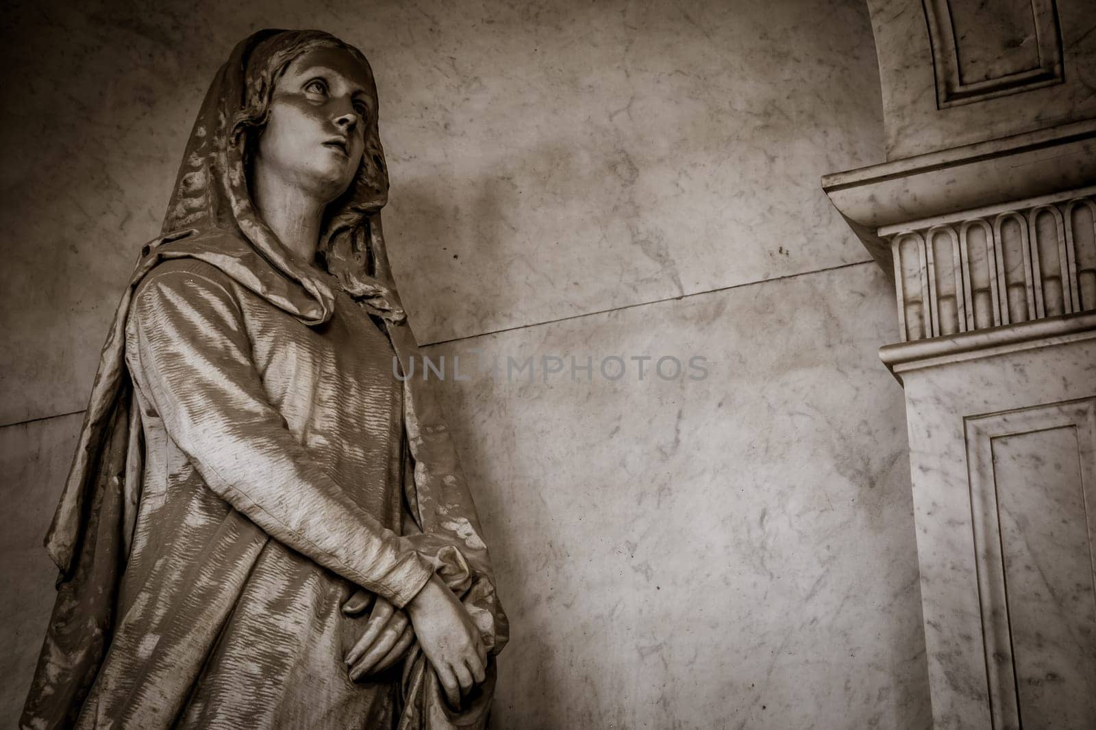 GENOA, ITALY - June 2020: antique statue, beginning 1800, made of marble, in a Christian Catholic cemetery - Italy