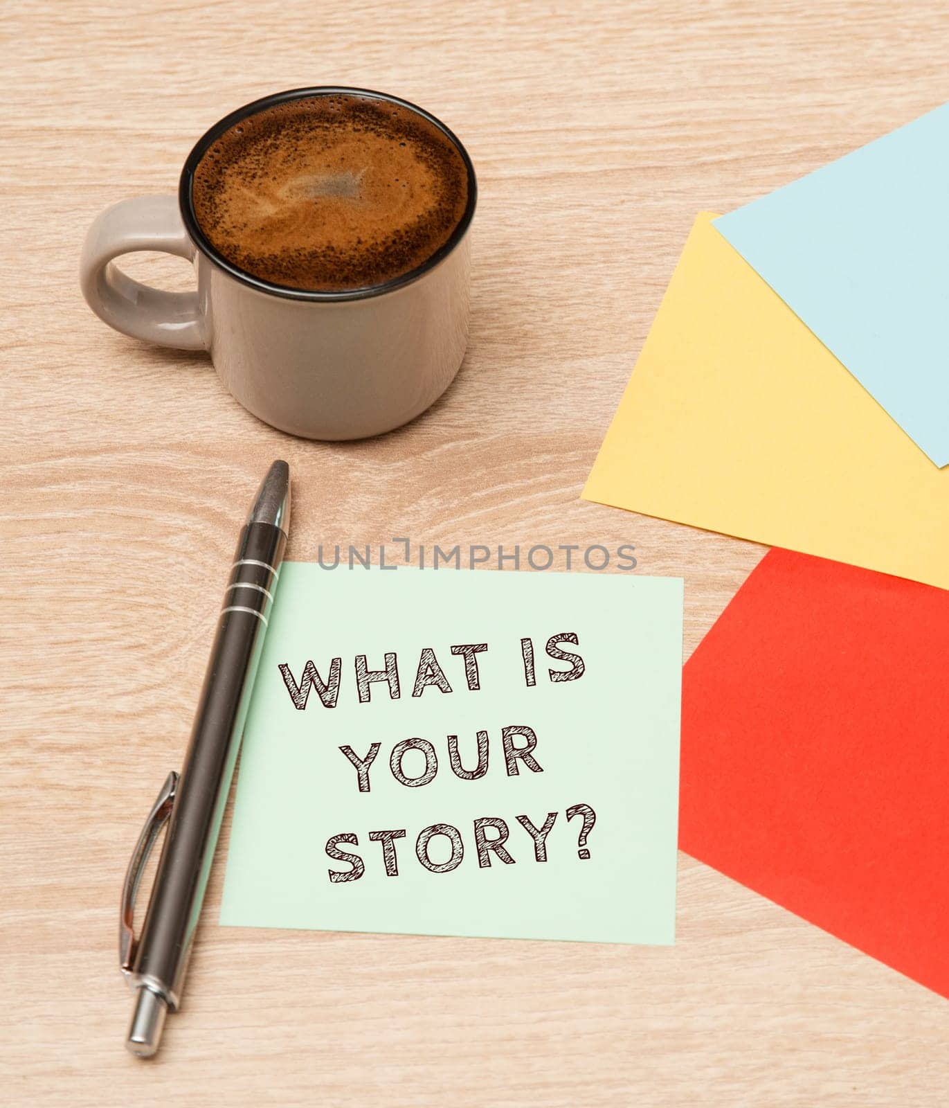 Story telling, cup coffee beside colorful paper, handwritten what is your story, concept business