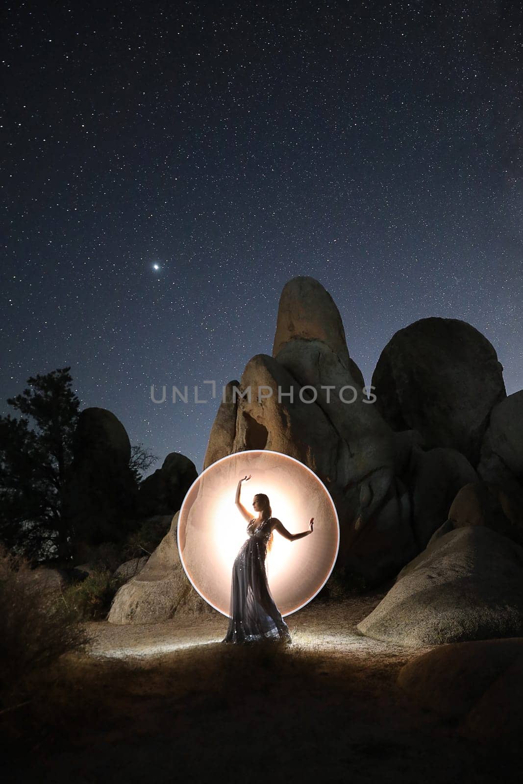 Light Painted Model Posing with Stars in Desert Setting