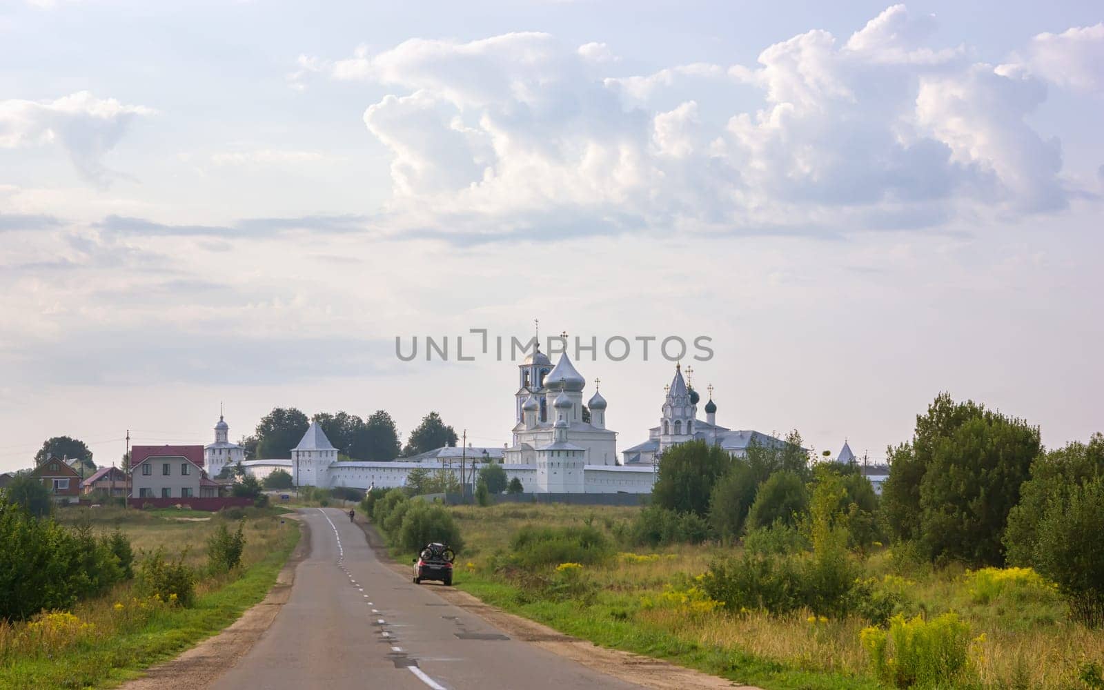 Pereslavl-Zalessky, Russia - August 10, 2021: The road leading to the Nikitsky Monastery - one of the most ancient monasteries of Russia, founded in the 12th century. Orthodox male monastery is part of the Pleshcheyevo Lake National Park.