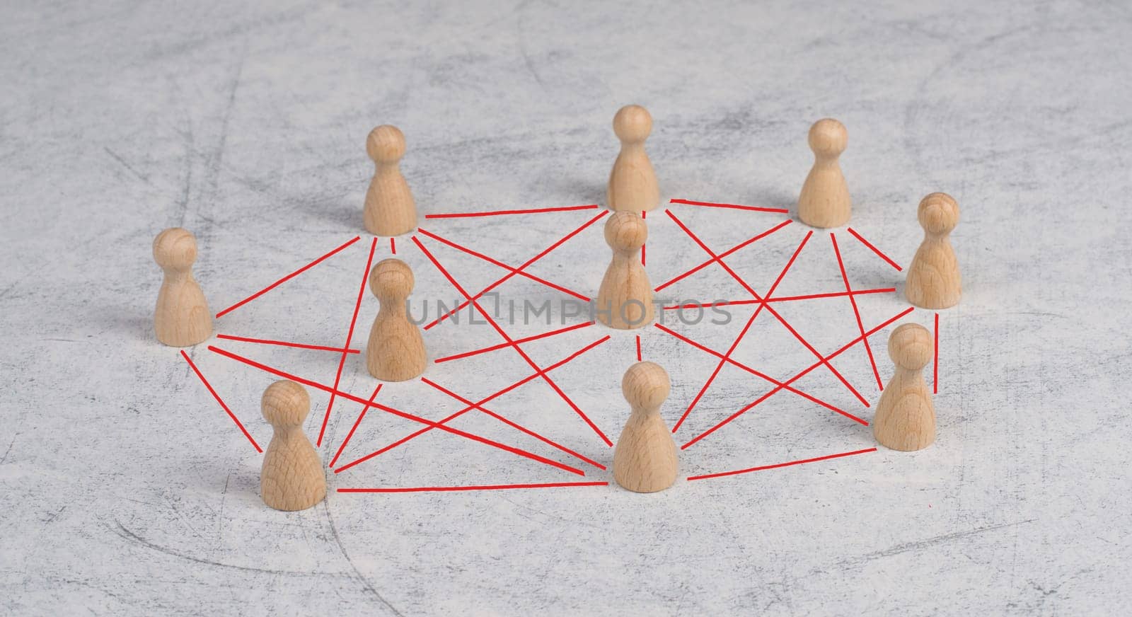 Group of wooden people connecting through red lines, communication between humans