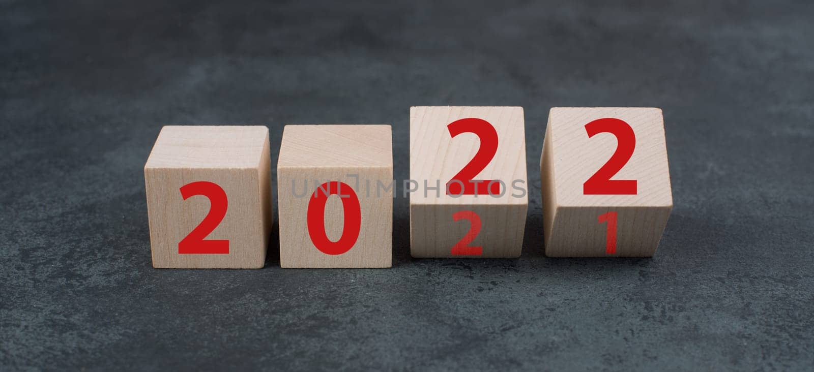 Changing the year 2021 to 2022, wooden cubes with red numbers, dark background