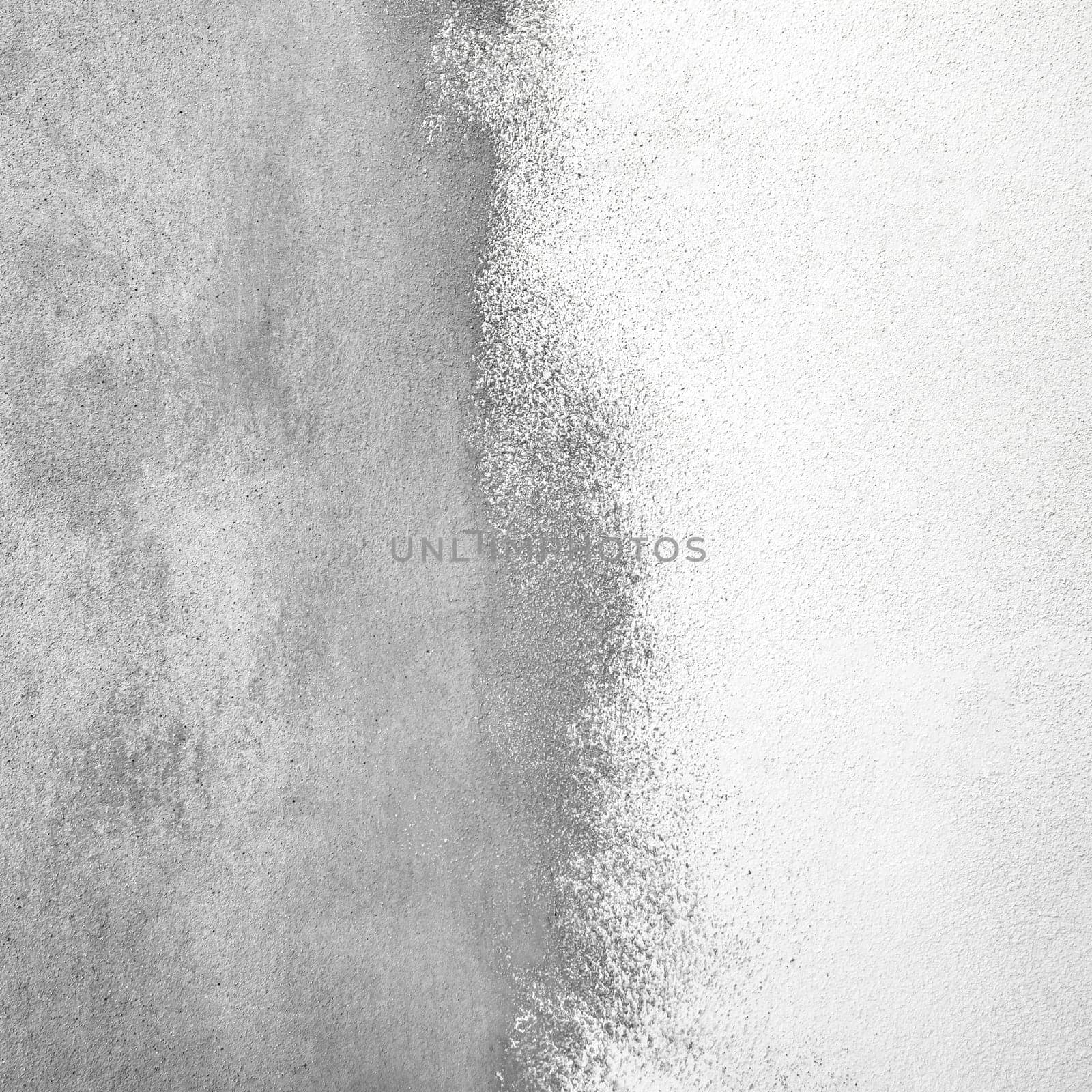 Decorative plaster surface. Grained abstract wall texture divided by half with white color putty.