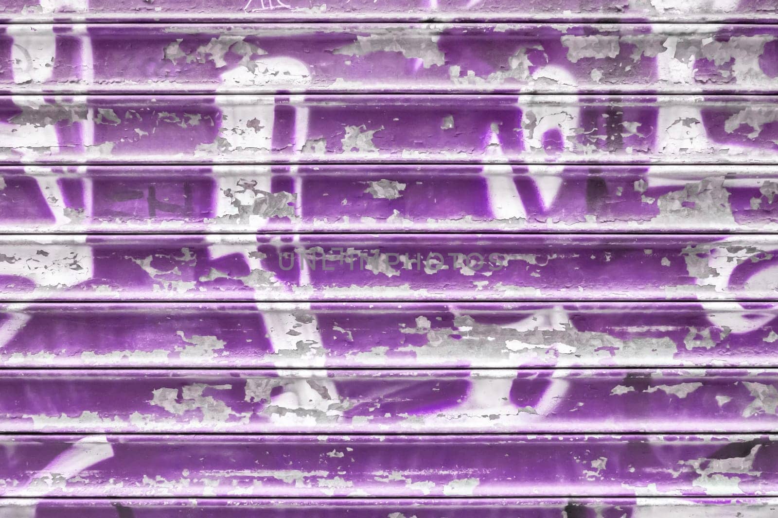 Violet metal shutter with peeling paint. Ideal use for background / wallpaper.