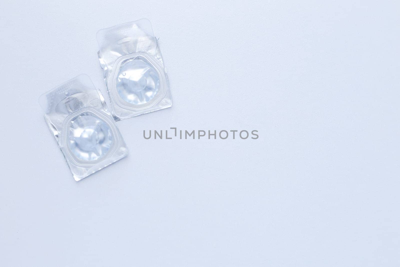 Contact lenses lie on the side on a white background.top view, flat lay, copy space, isolate. High quality photo