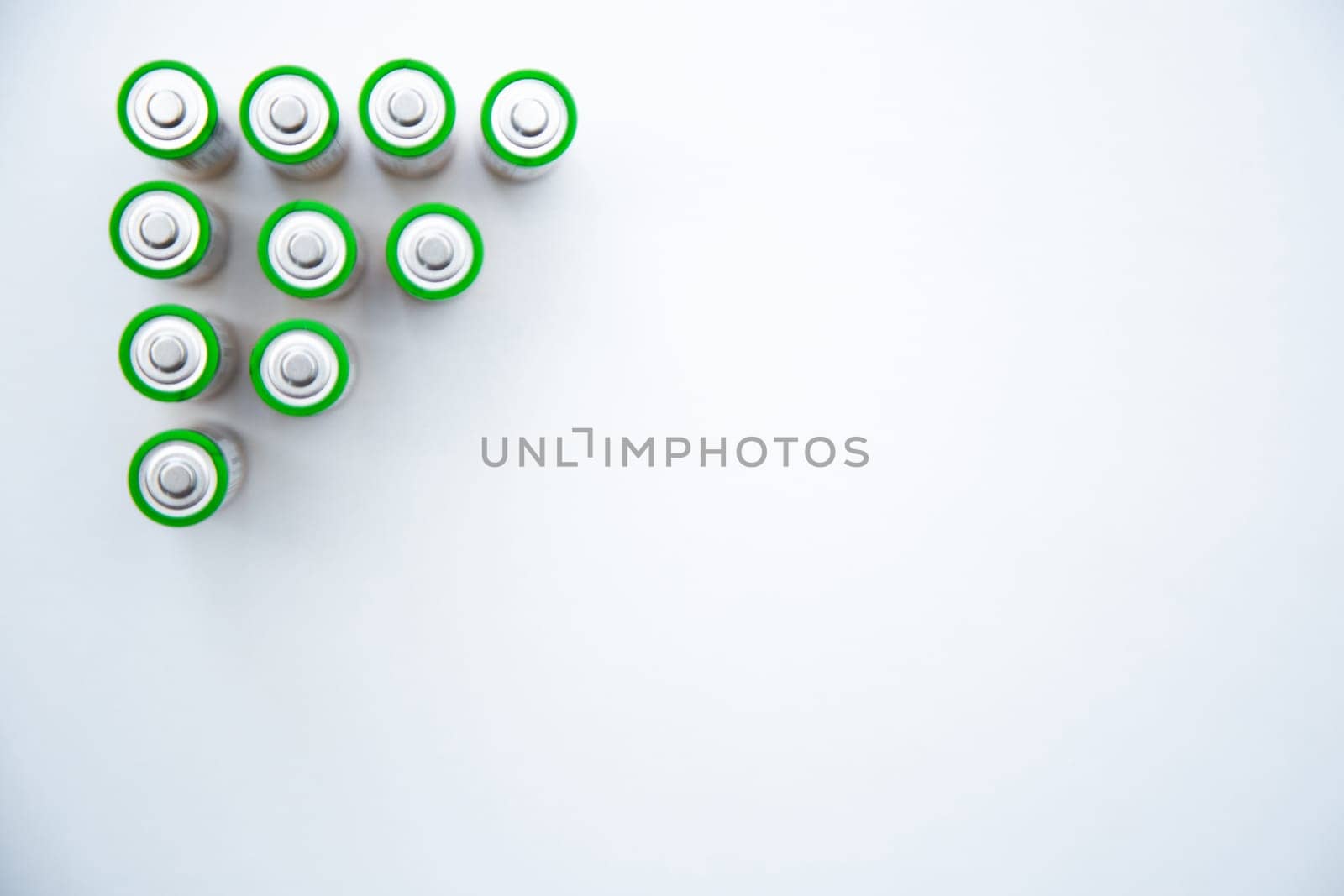The batteries are arranged in a triangle in the upper corner of the photo on a white background. top view, flat lay, copy space, isolate. High quality photo