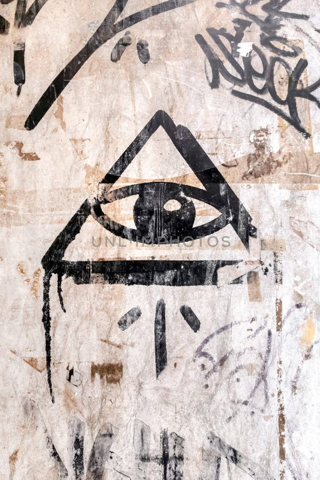 Illuminati logo painted on the wall. "All seeing eye"" of God in sacred geometry triangle. Masonry and Illuminati symbol in triangle with light ray."