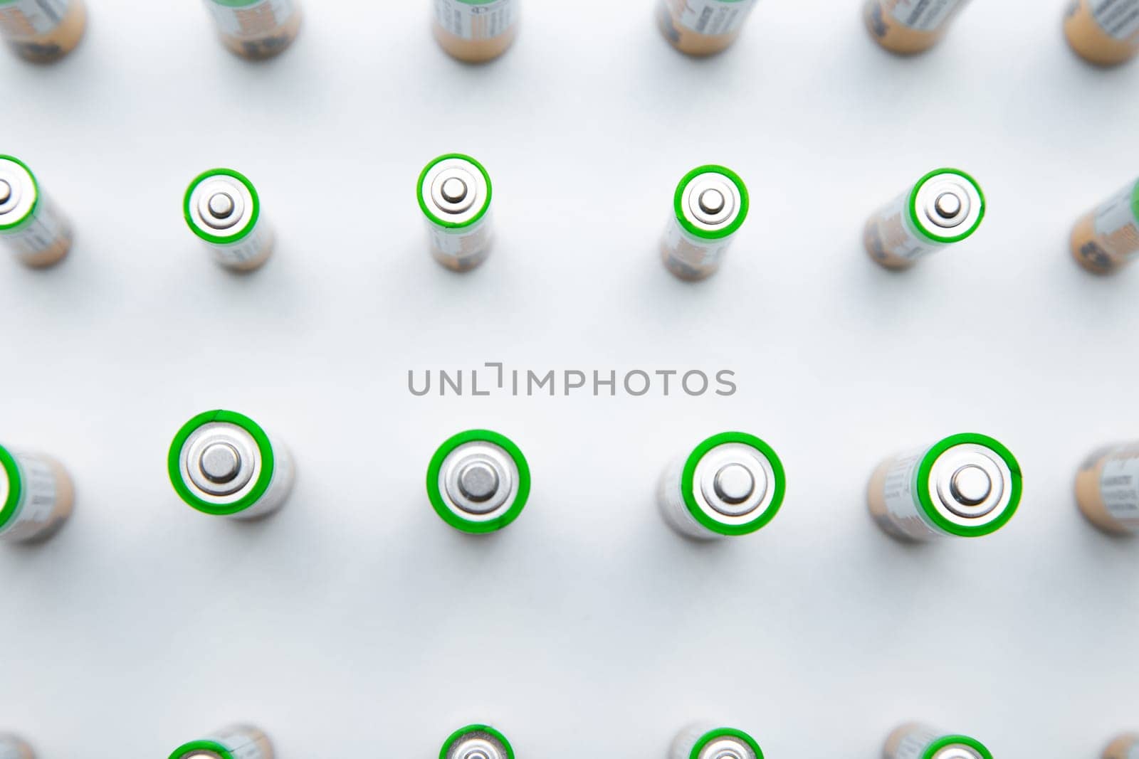 The batteries are arranged in a triangle in the upper corner of the photo on a white background. top view, flat lay, copy space, isolate. High quality photo