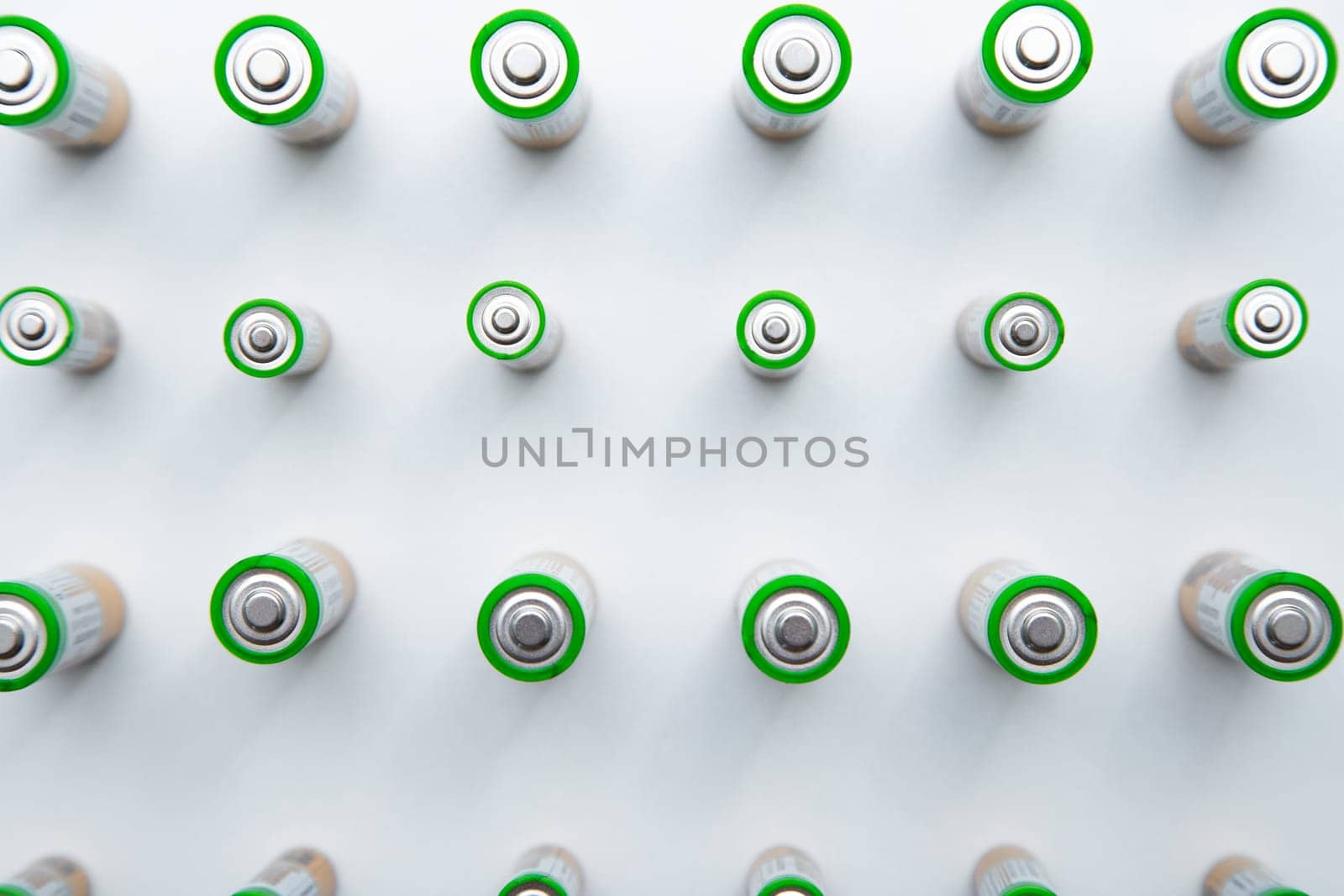 The batteries are arranged in a triangle in the upper corner of the photo on a white background. top view, flat lay, copy space, isolate. High quality photo