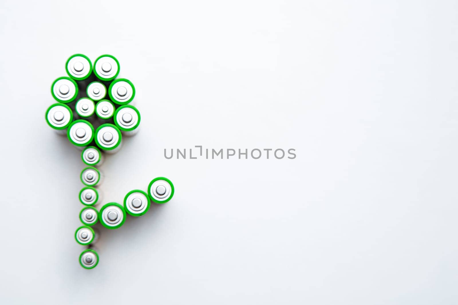 The batteries are in the shape of a flower on a white background. top view, flat lay, copy space, isolate. High quality photo