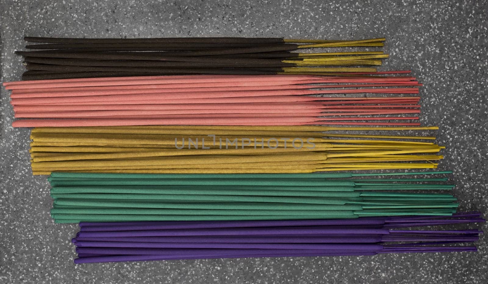 Indian or thai colorful incense aroma sticks variety scattered on a table, top view