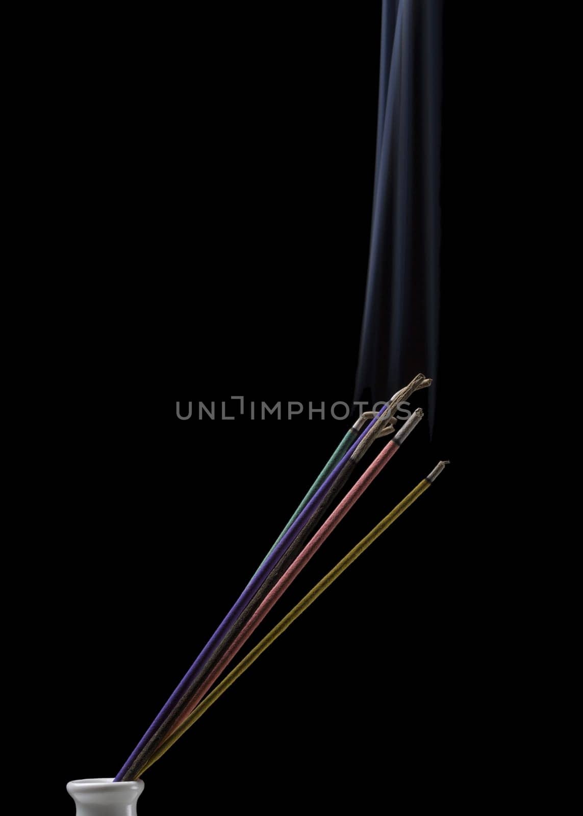 Burning indian or thai incense aroma sticks variety with smoke, isolated on black