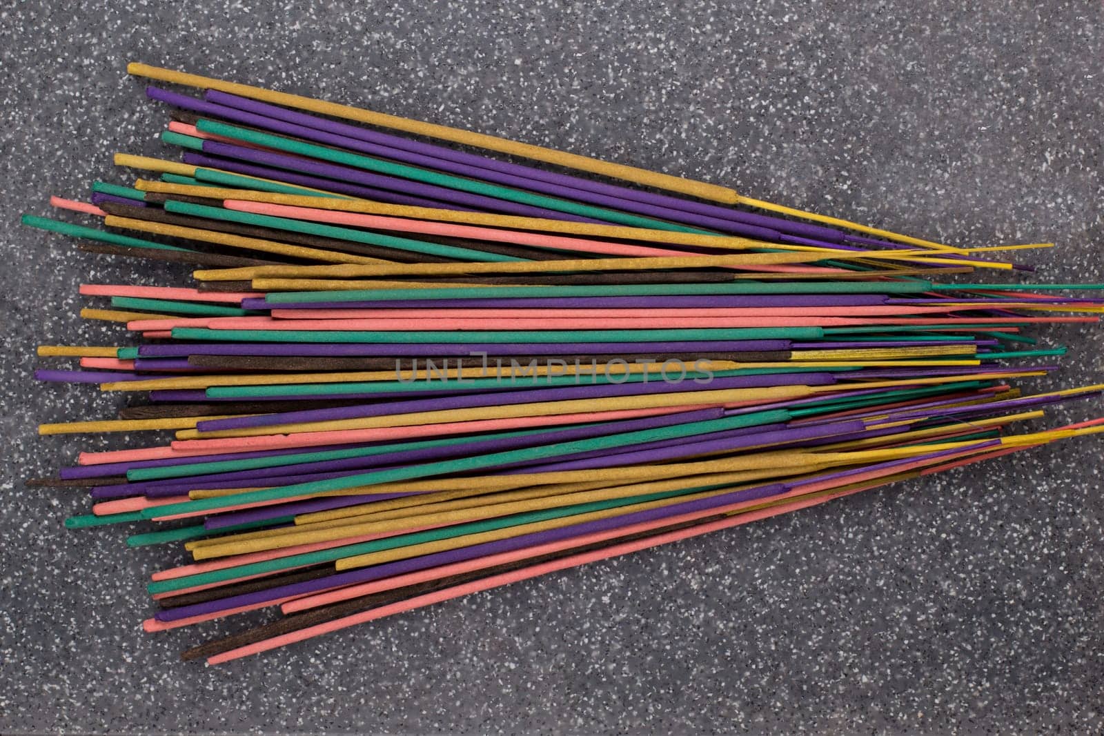 Indian or thai colorful incense aroma sticks variety scattered on a table, top view