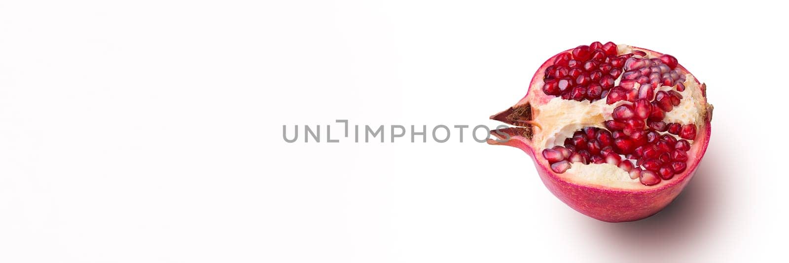 Garnet isolated part on a white background close-up with shadow. Fresh pomegranate. Juicy pomegranate. Delicious pomegranate. Place for advertising, logo, lettering, layout, mockup.