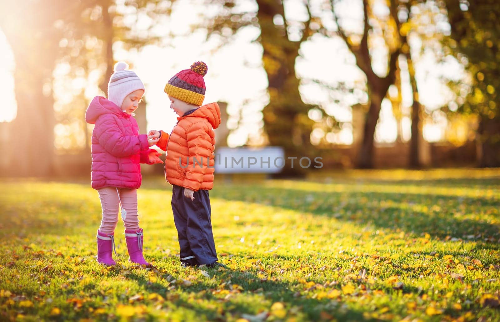 Two children playing in the park together. Concept of family relationship and friendship.