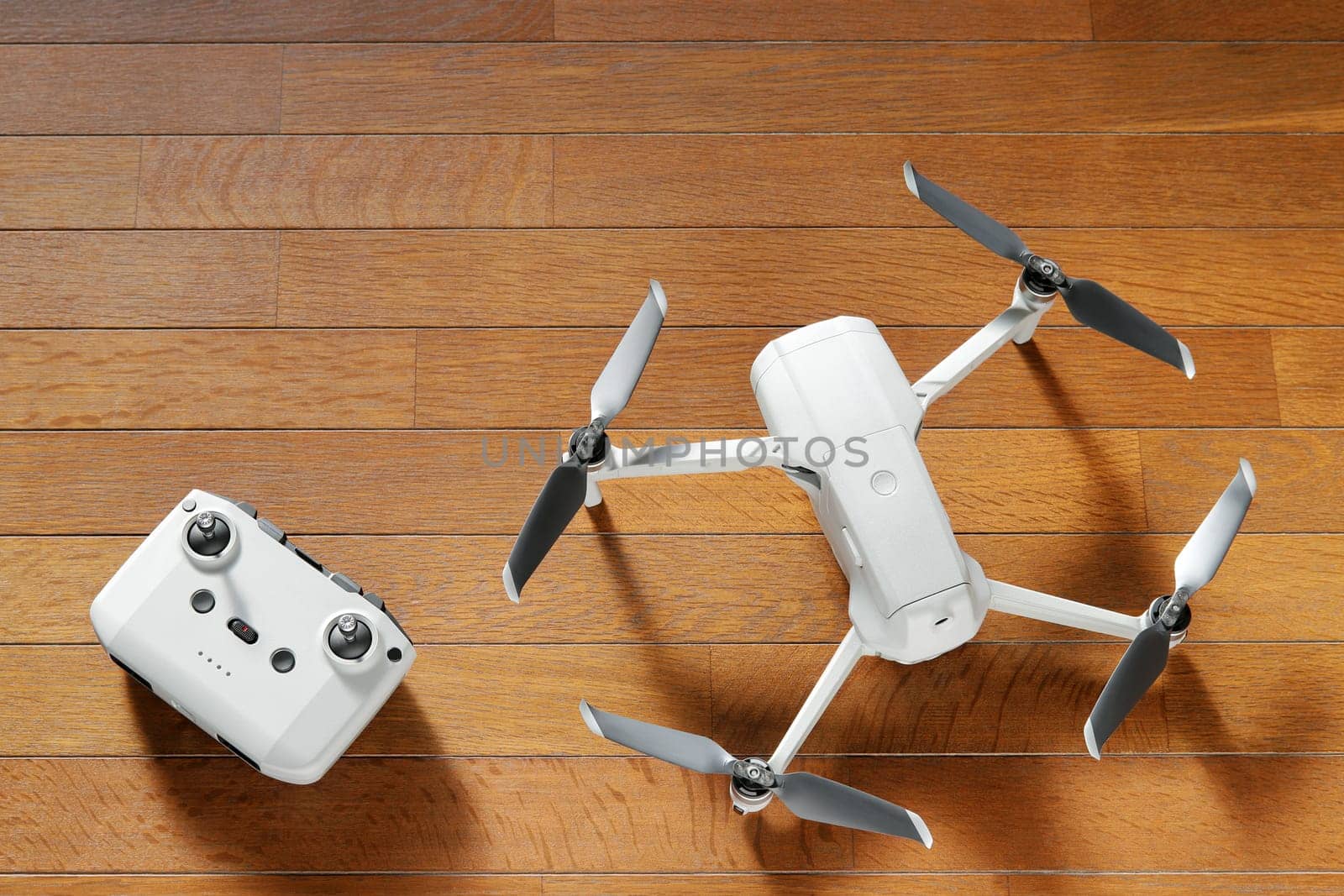 small drone copter with controller on a wooden background