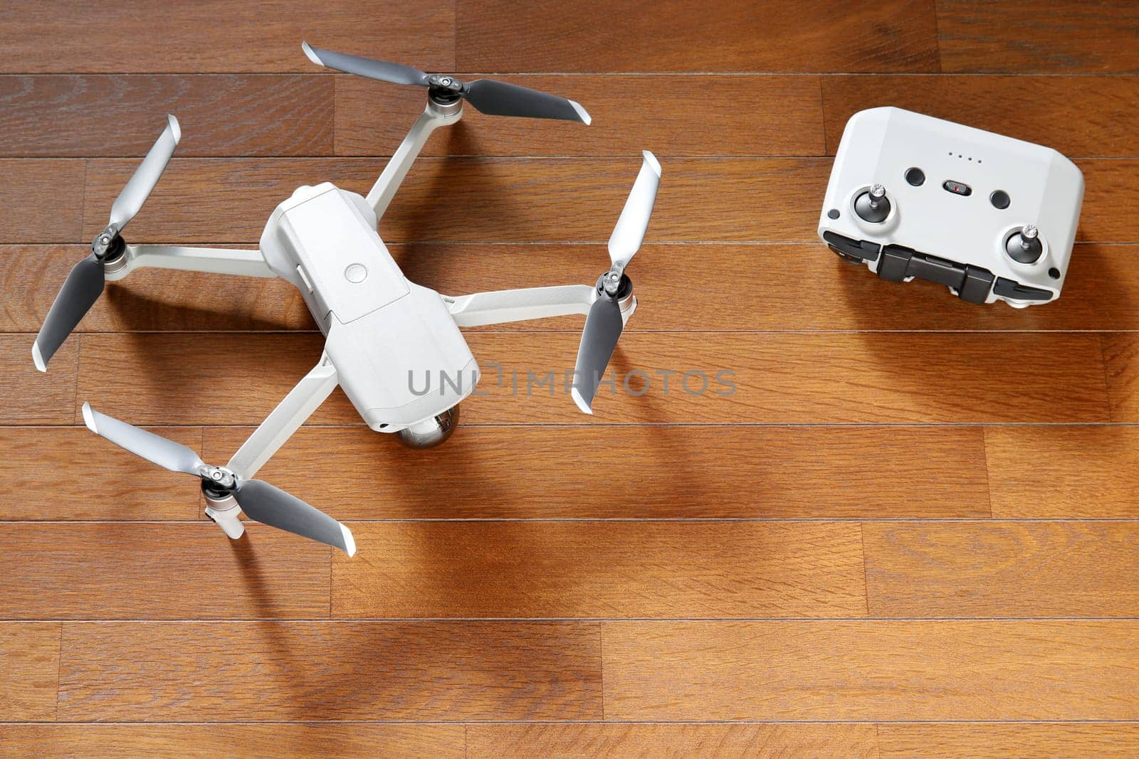 small drone copter with controller on a wooden background
