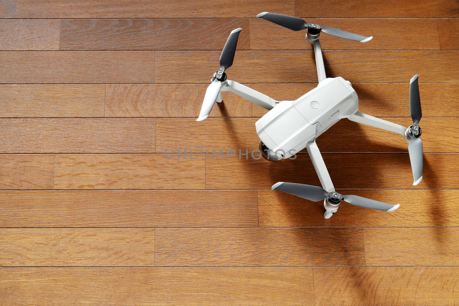 small drone copter on a wooden background