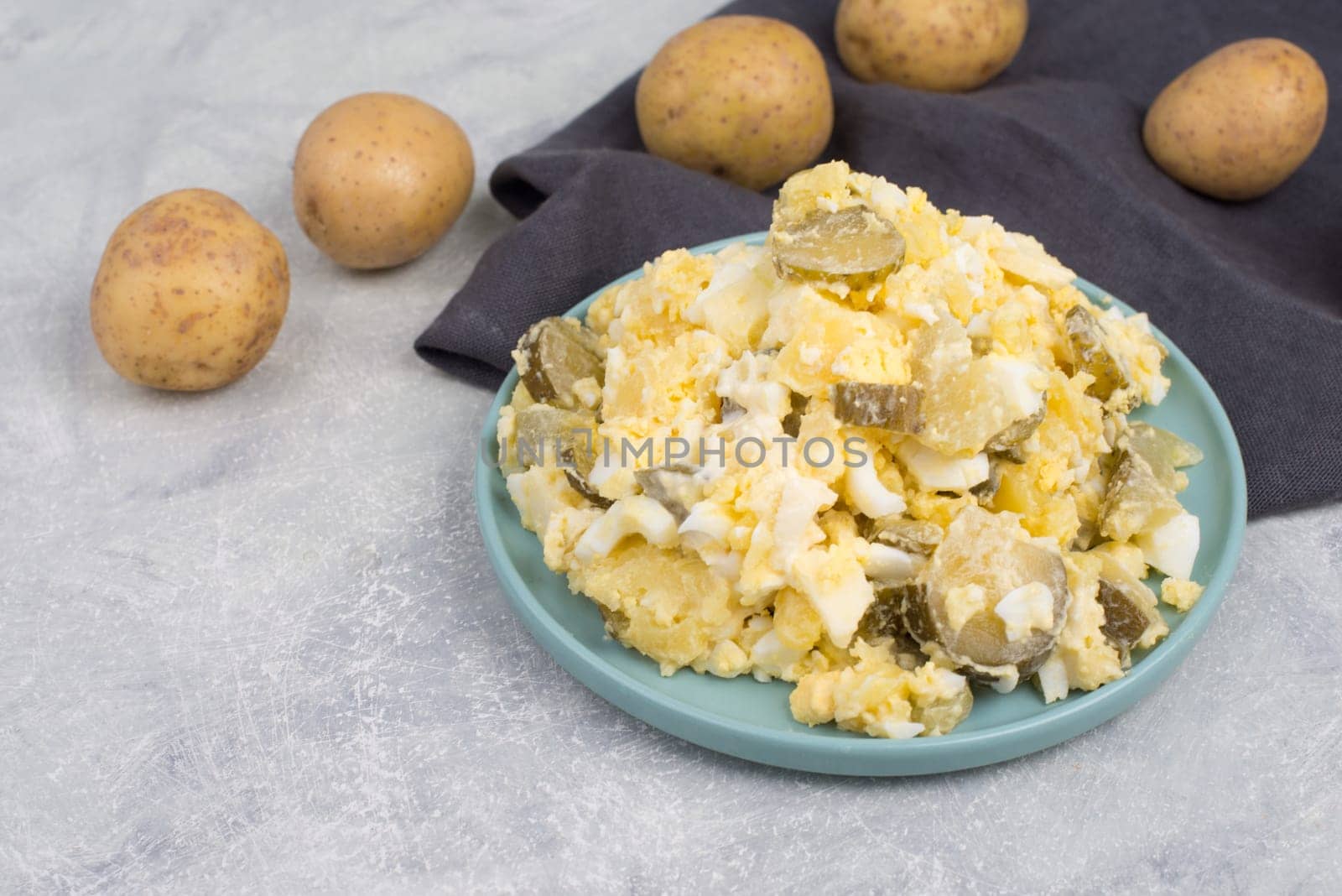 Potato salad on a blue coloredplate, traditional german food