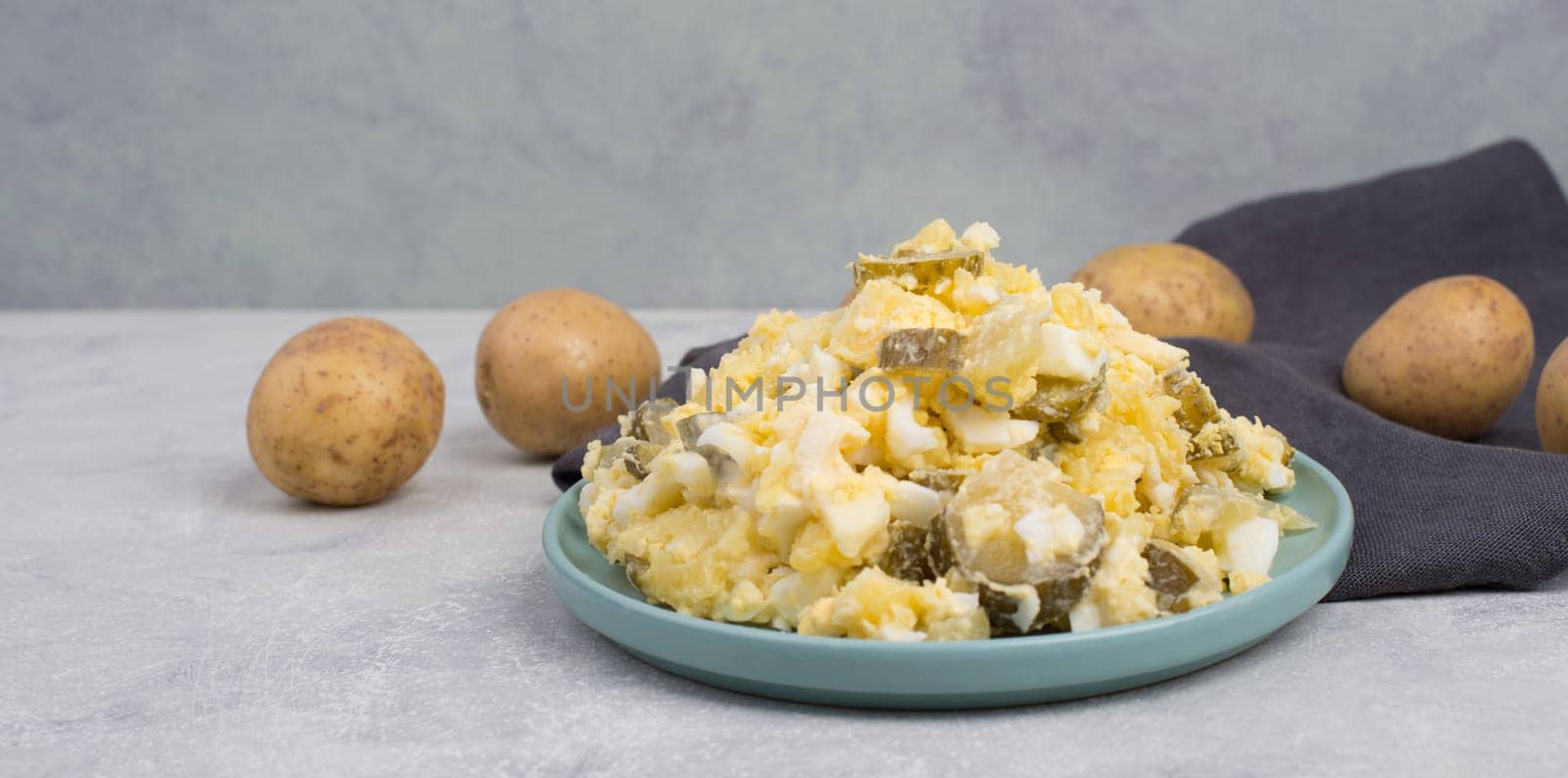 Potato salad on a blue coloredplate, traditional german food