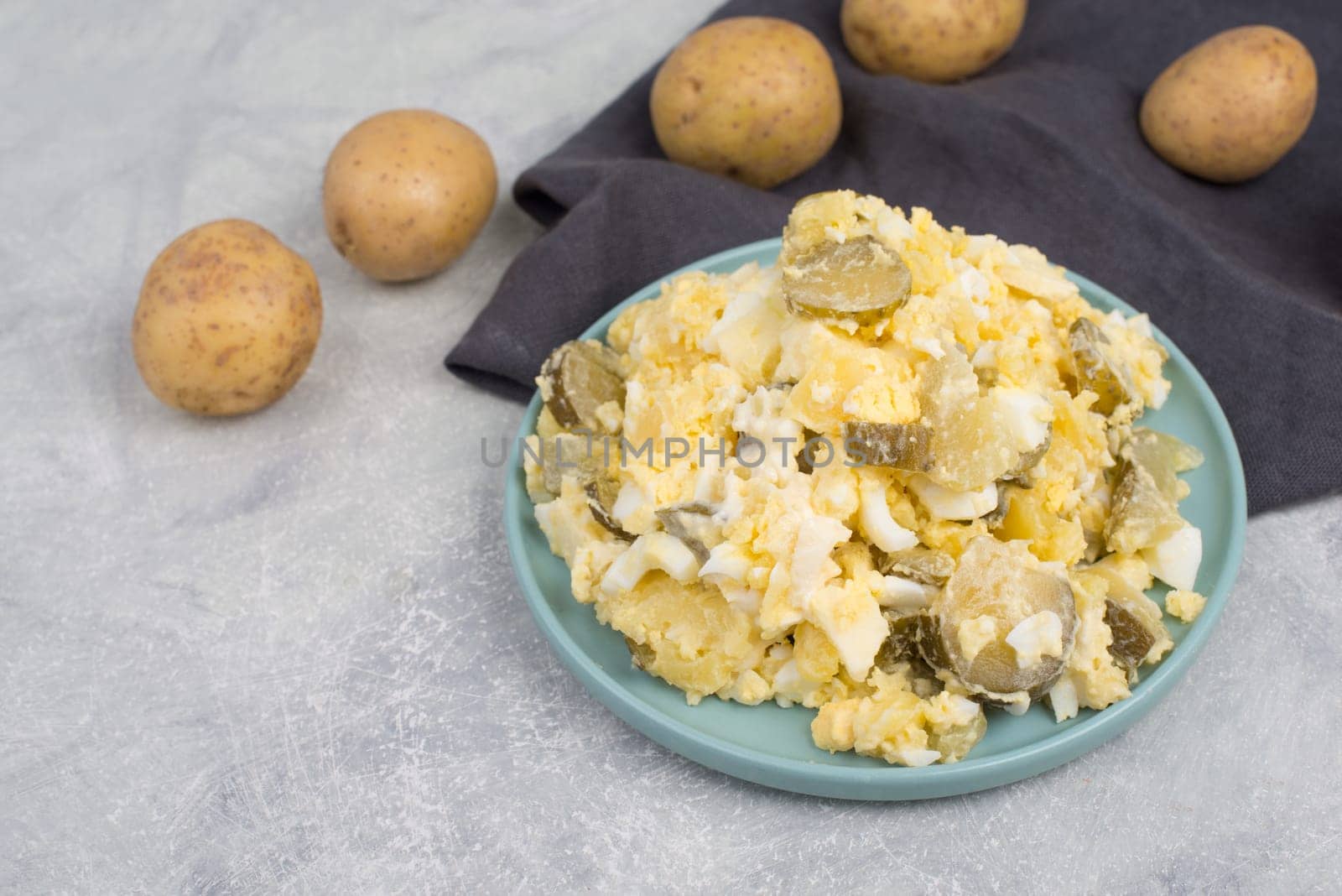 Potato salad on a blue coloredplate, traditional german food