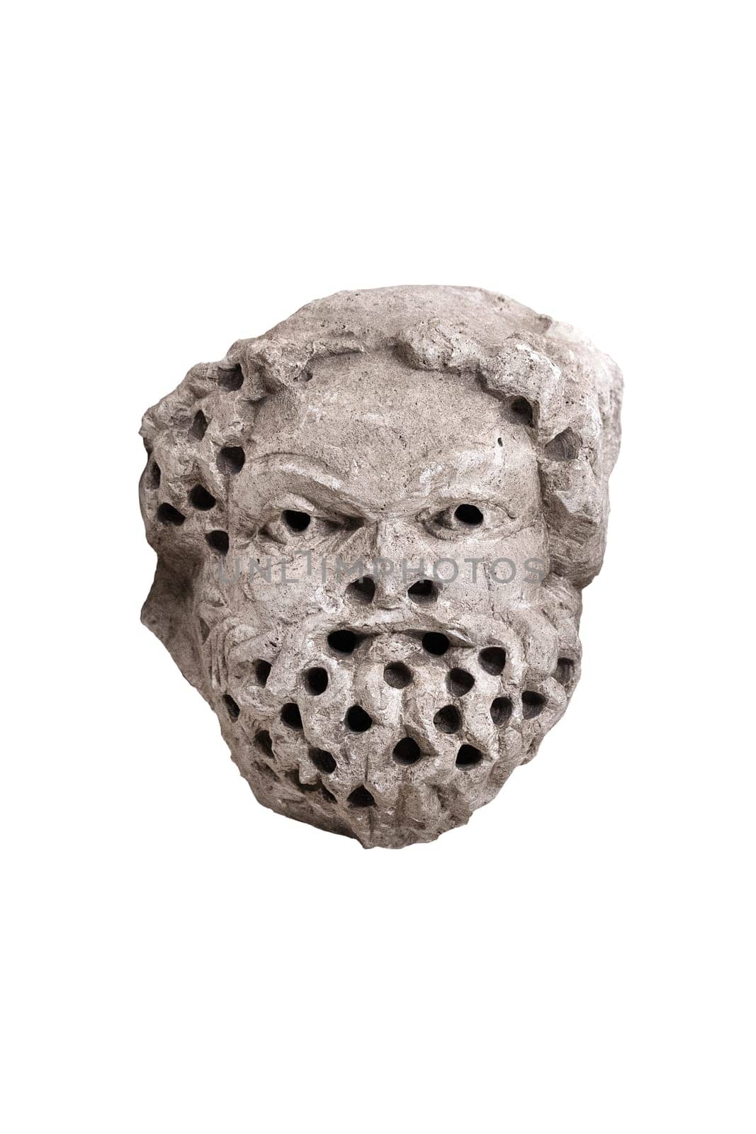 antique male demon stone statue head with open mouth and holes in hair and beard isolated on white background