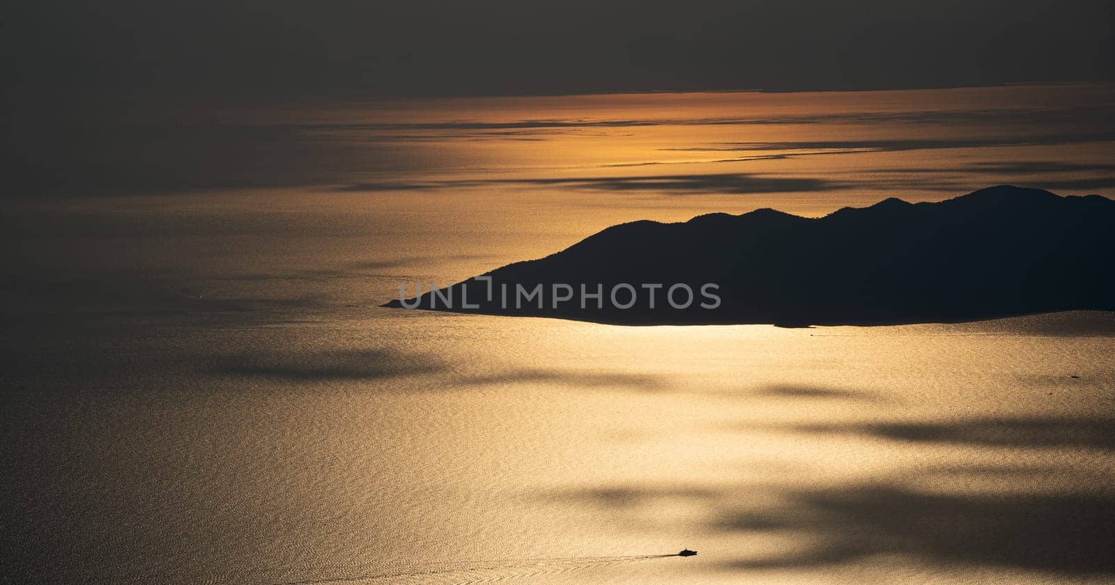 beautiful aerial panorama from the Babadag peak of high mountains rising up over the Mediterranean sea at sunset near Oludeniz Blue Lagoon coast in Turkey during summer