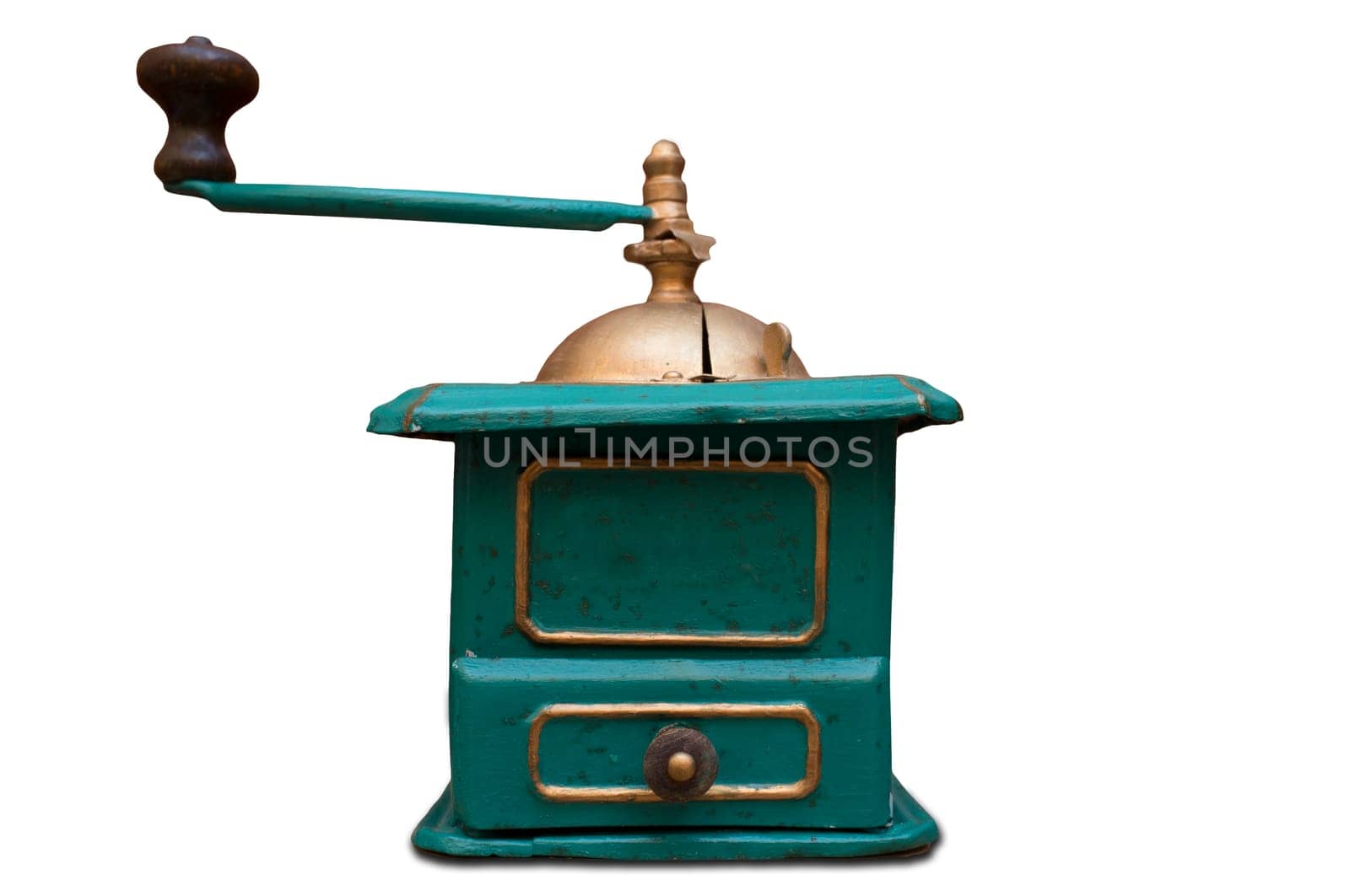 Old manual coffee grinder painted gold and green. Selective focus
