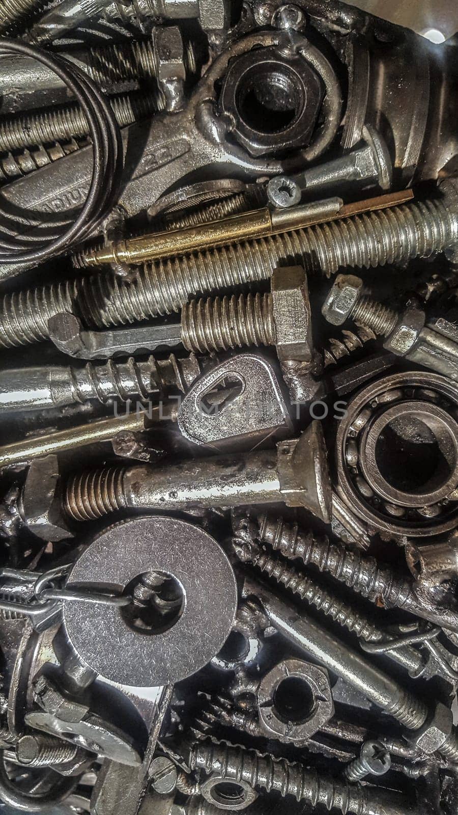 Jumble of used metal pieces as a old hex keys or bolts. Closeup