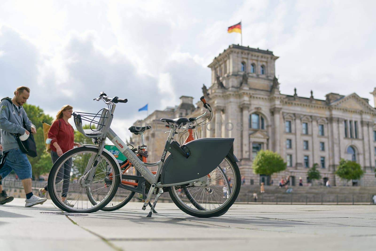 Bicycle of the public bicycle rental system of the city of Berlin Nextbike in the government district. In the background the Reichstag.