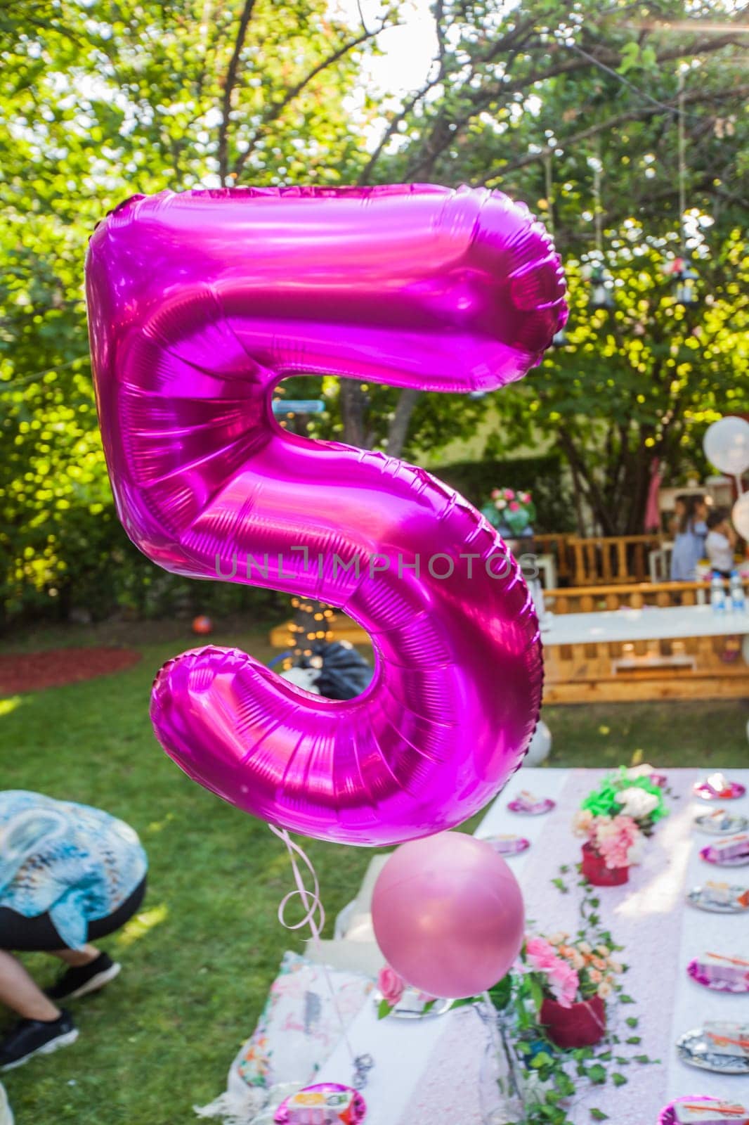 Happy Birthday decoration. Birthday Balloon At Summer Garden Party. Number Five Violet Balloon.
