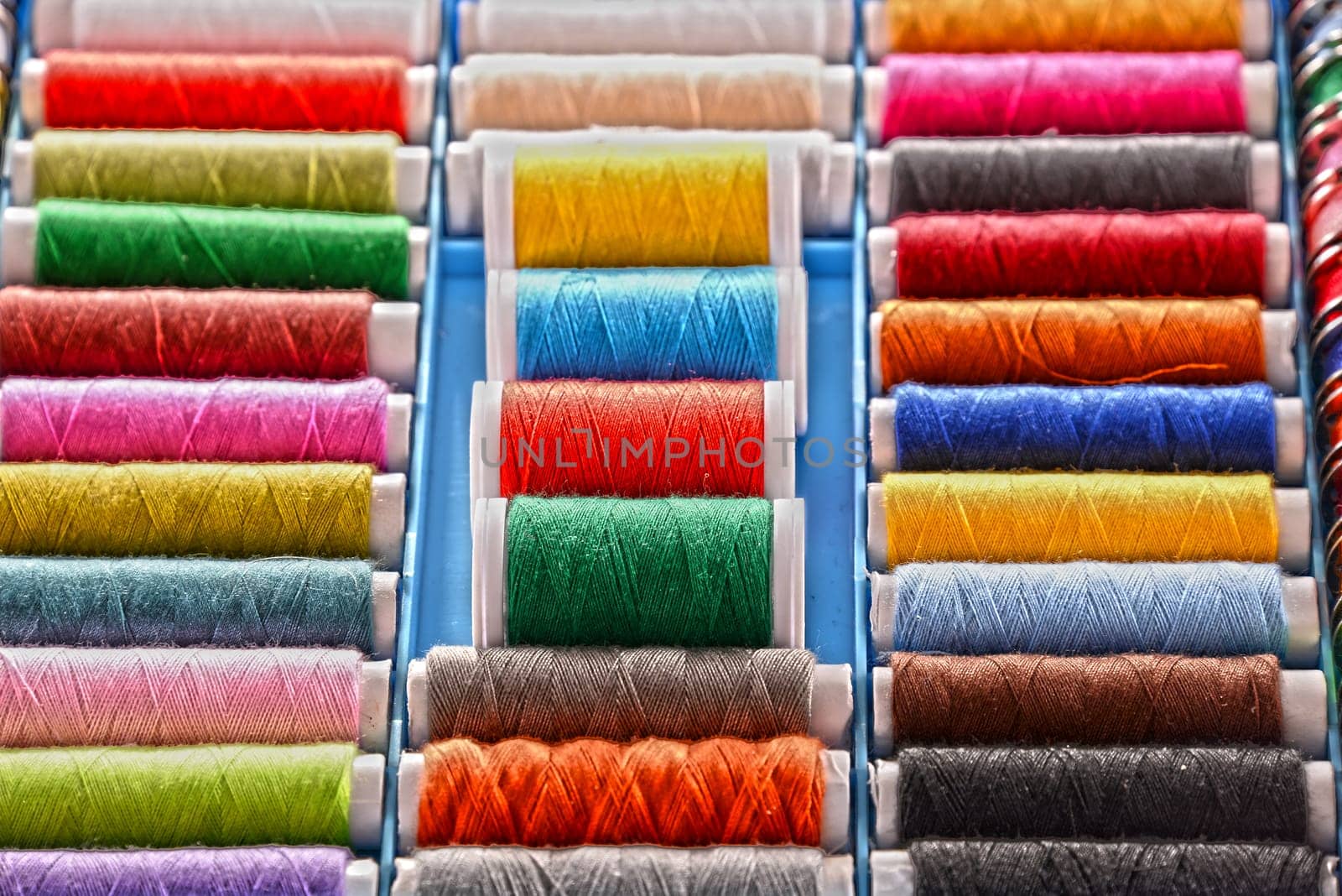 Composition with tailor threads in a box.