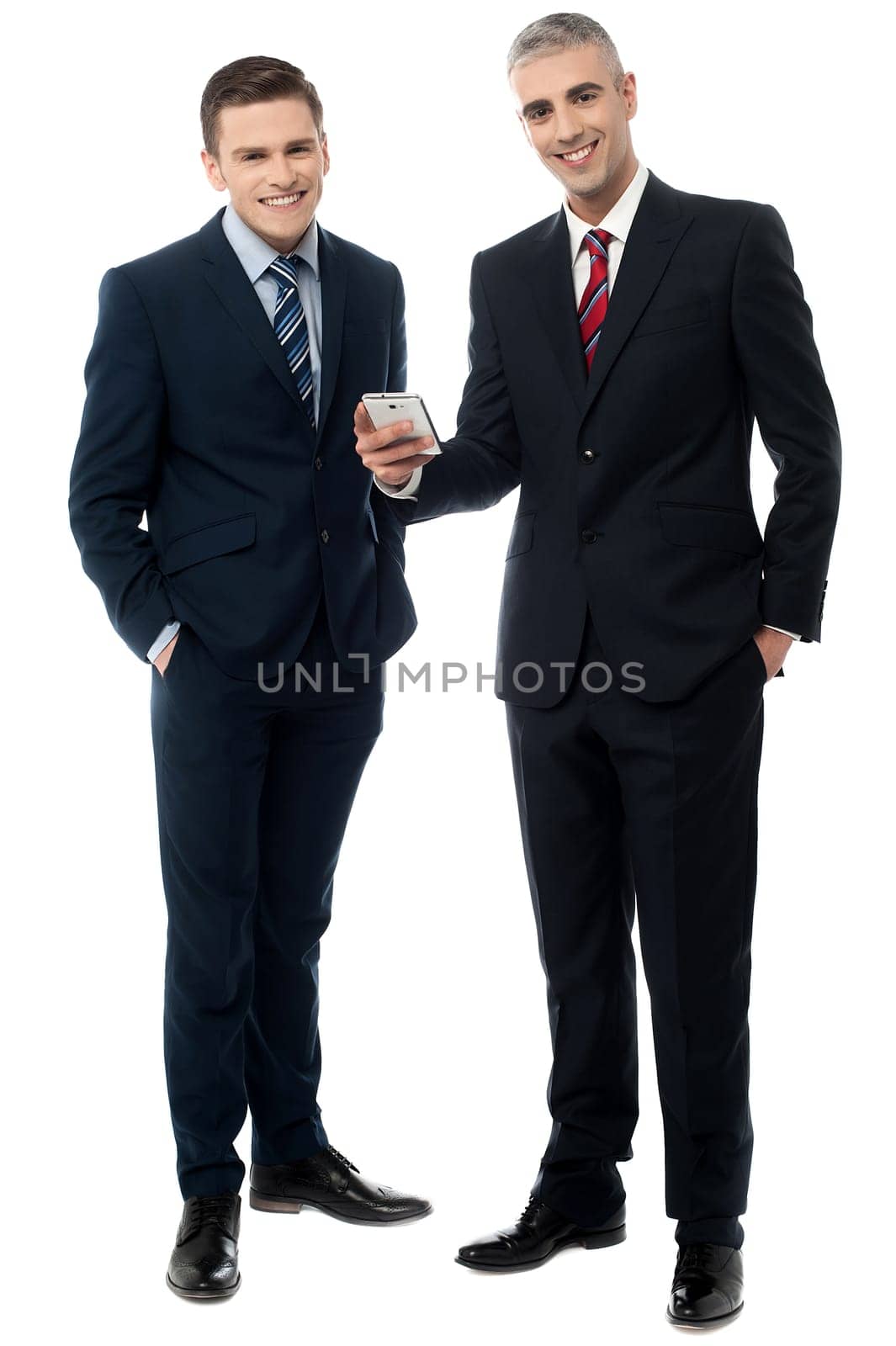 Happy businessmen browsing on mobile phone