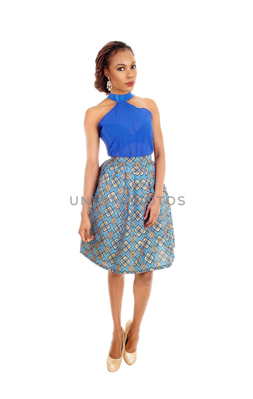 A beautiful slim African American woman standing in a lovely skirt.and blue blouse isolated for white background..