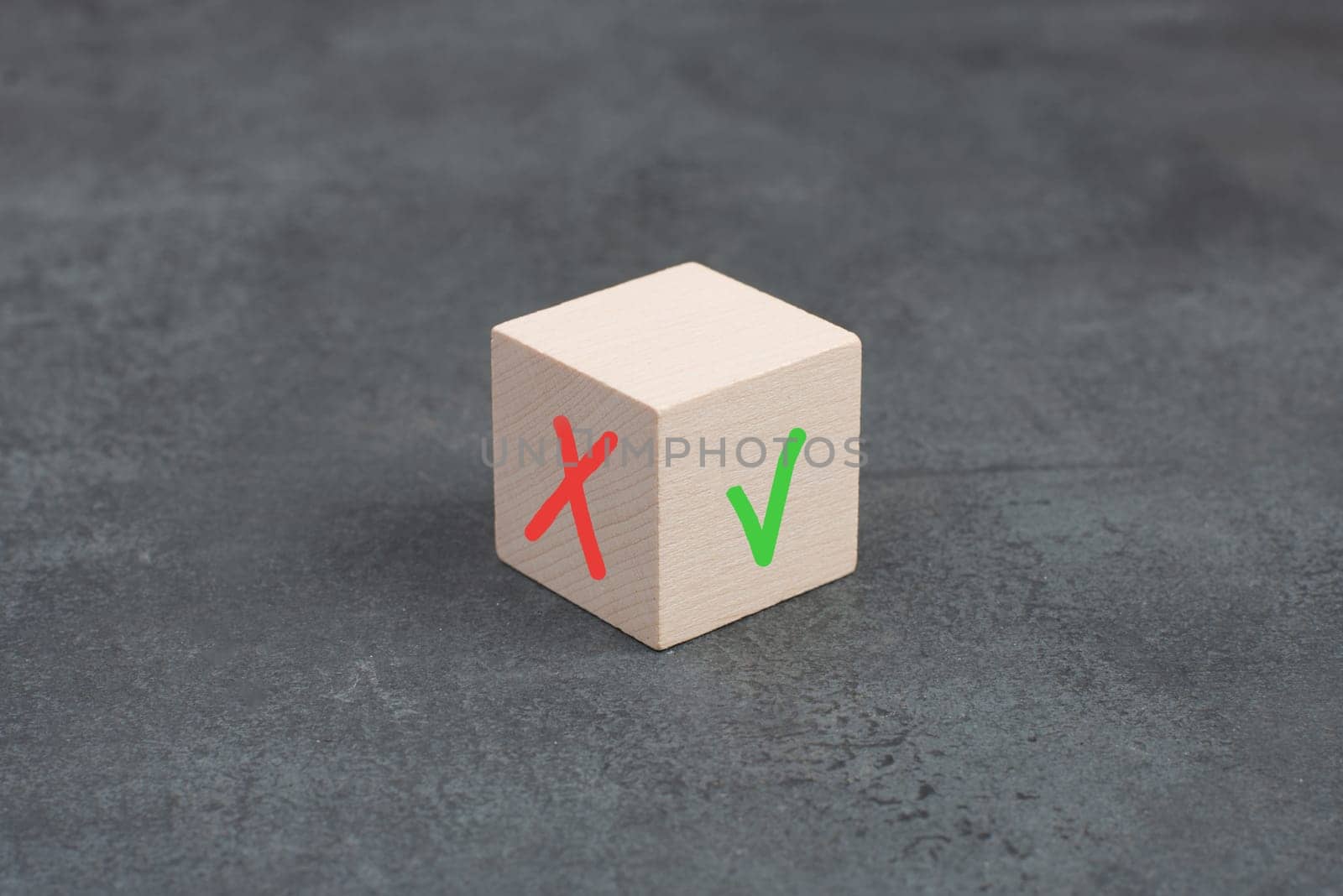 Wooden cube with a tick and a cross, desicion making, choosing between options