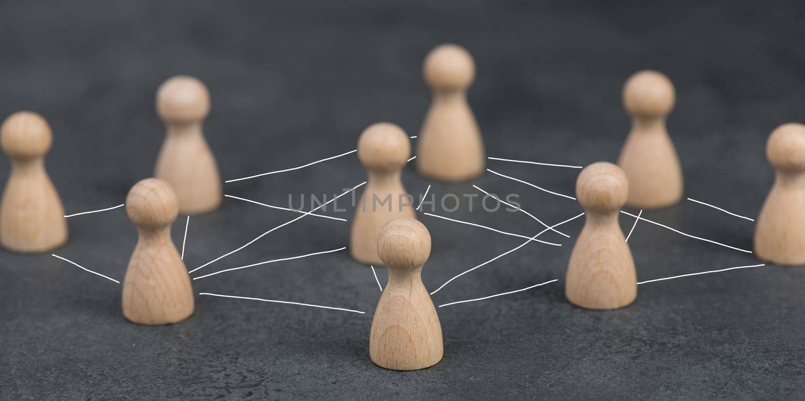 Wood figures, roup of people connecting through a web, business networking and communication