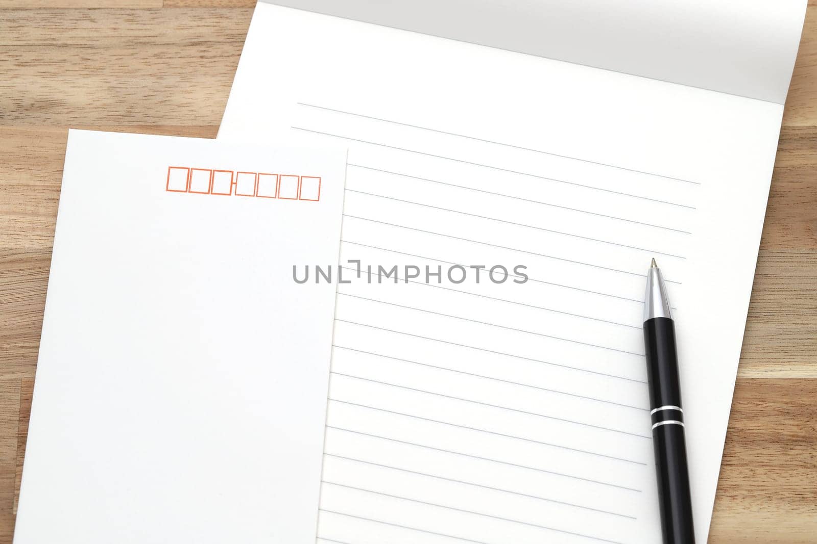 Japanese writing letter paper with ballpoint pen on wooden background