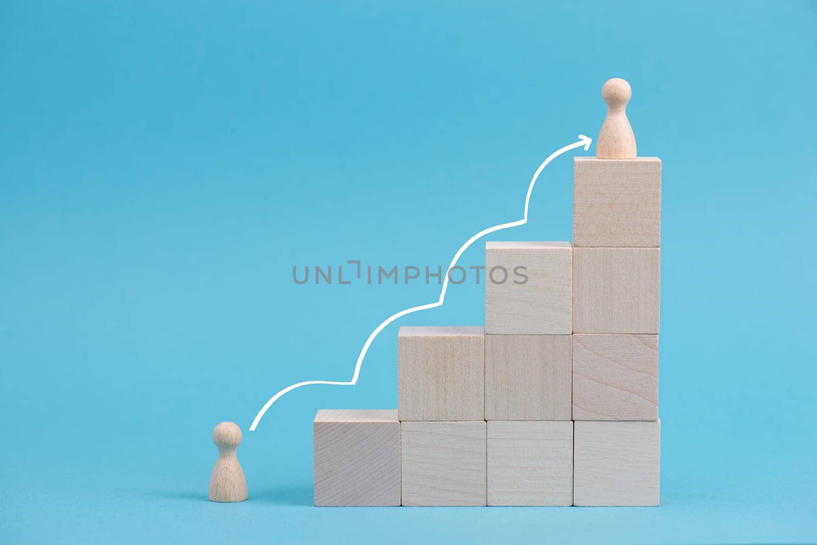 Wooden cubes building stairs, on person is standing at the bottom and the other men is standing on top, different positions