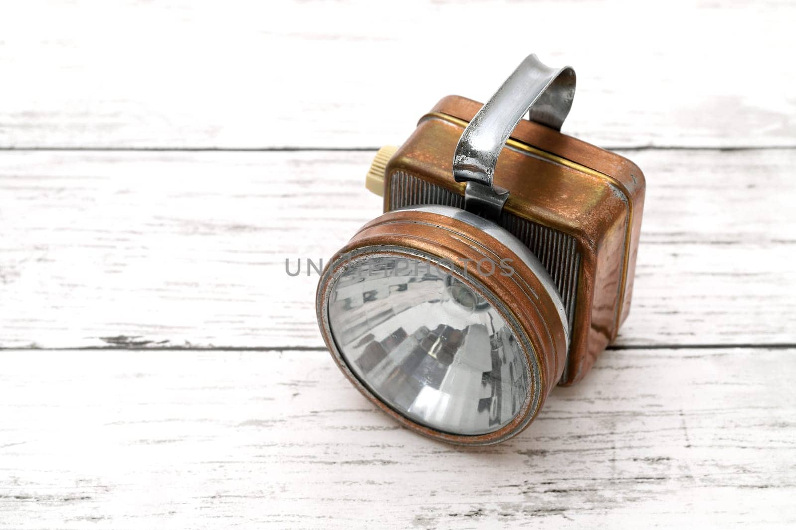 Retro electric flashlight isolated on white background