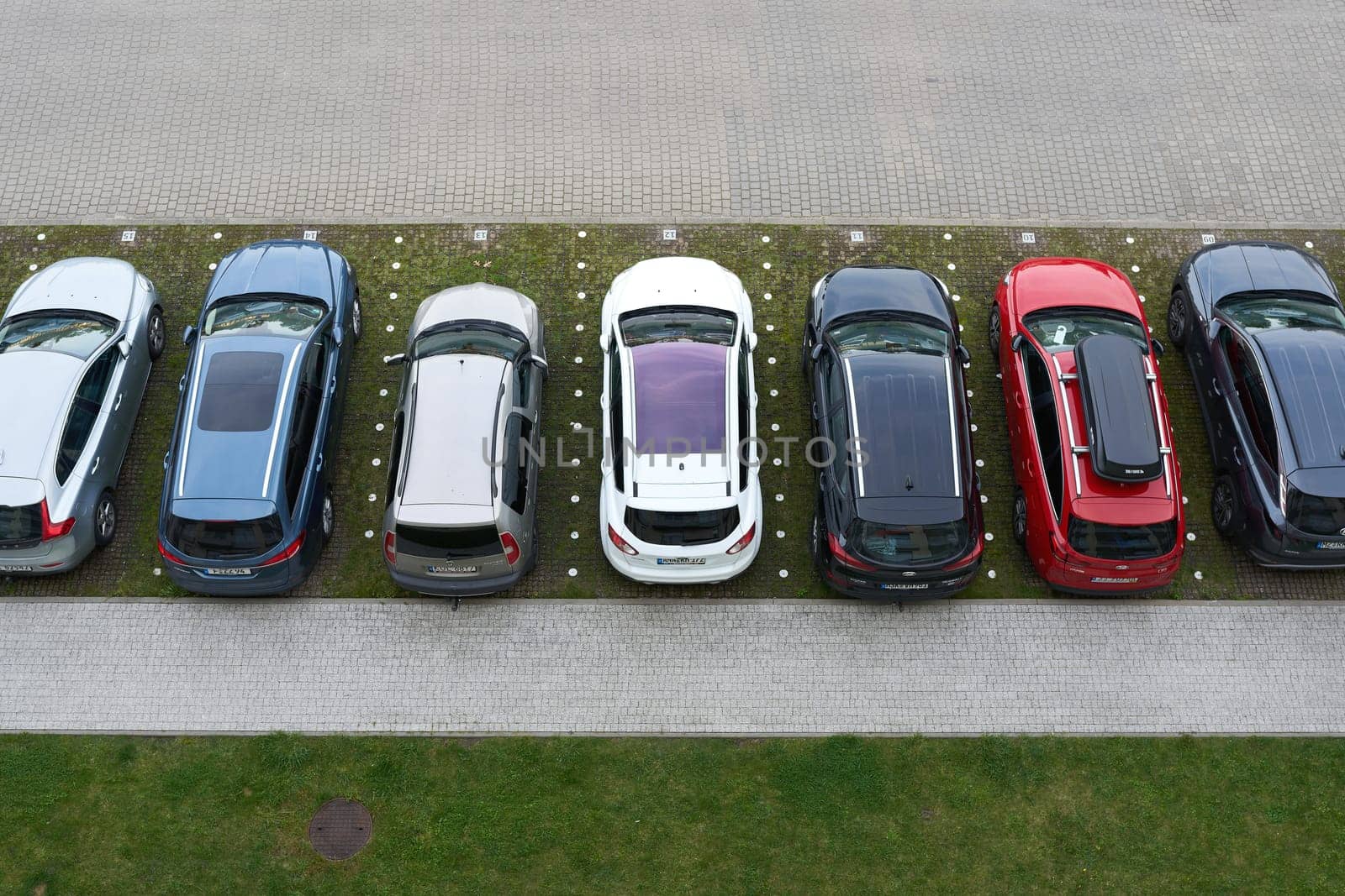 Parking lot with cars in front of a hotel in the city of Kolobrzeg in Poland from bird's eye view