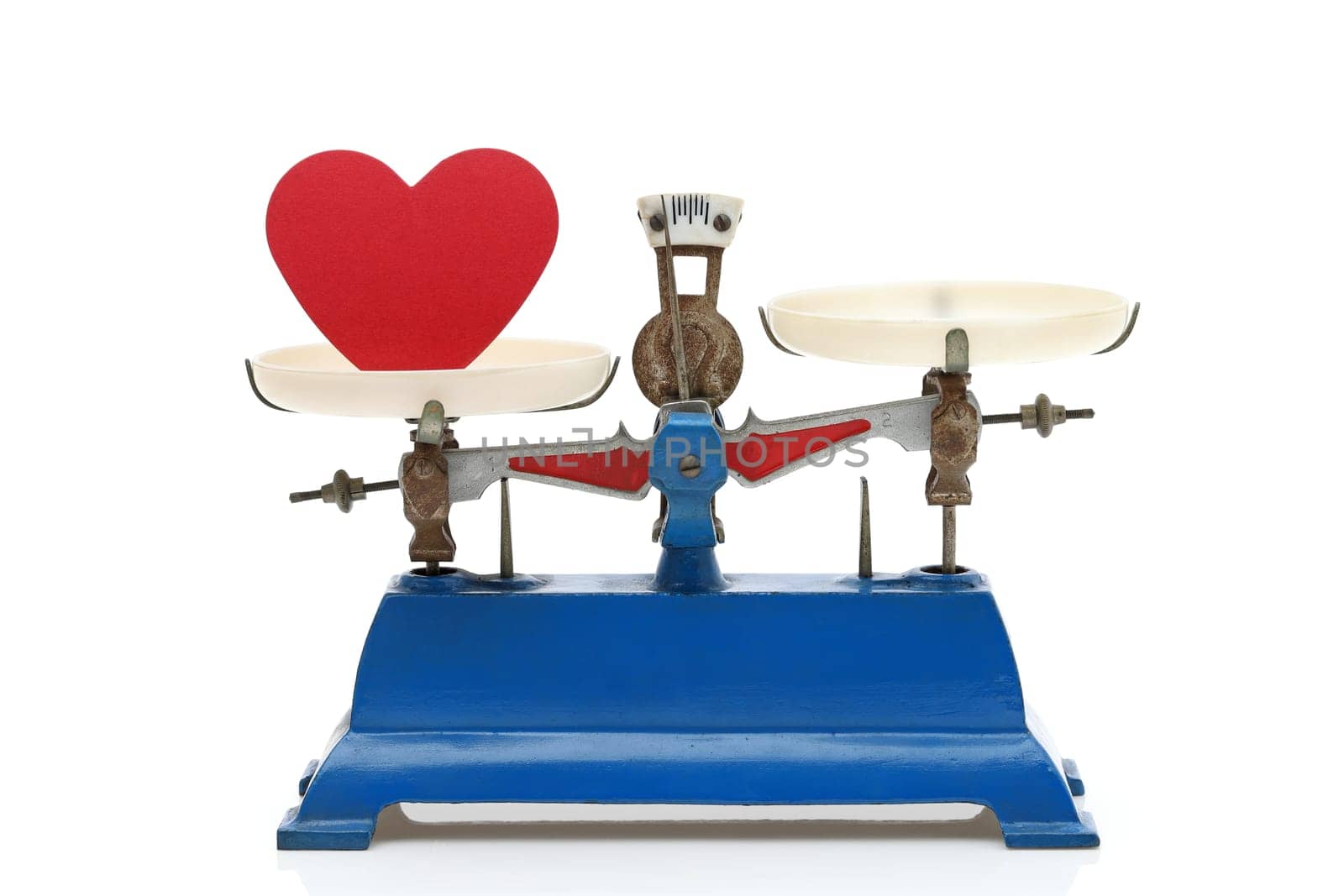 Retro roberval balance with red heart, scale on a white background