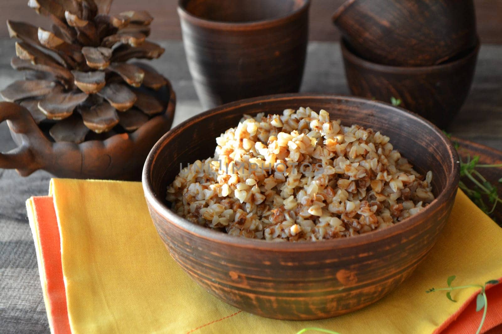 Buckwheat Porridge in rustic bowl on yellow napkin