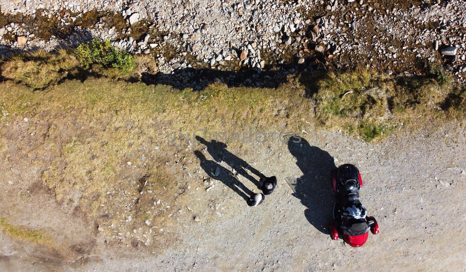Aerial shot with drone of two people and spyder with shadow