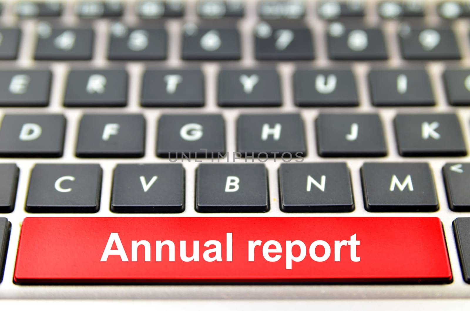 Annual report word on computer keyboard, 3D rendering