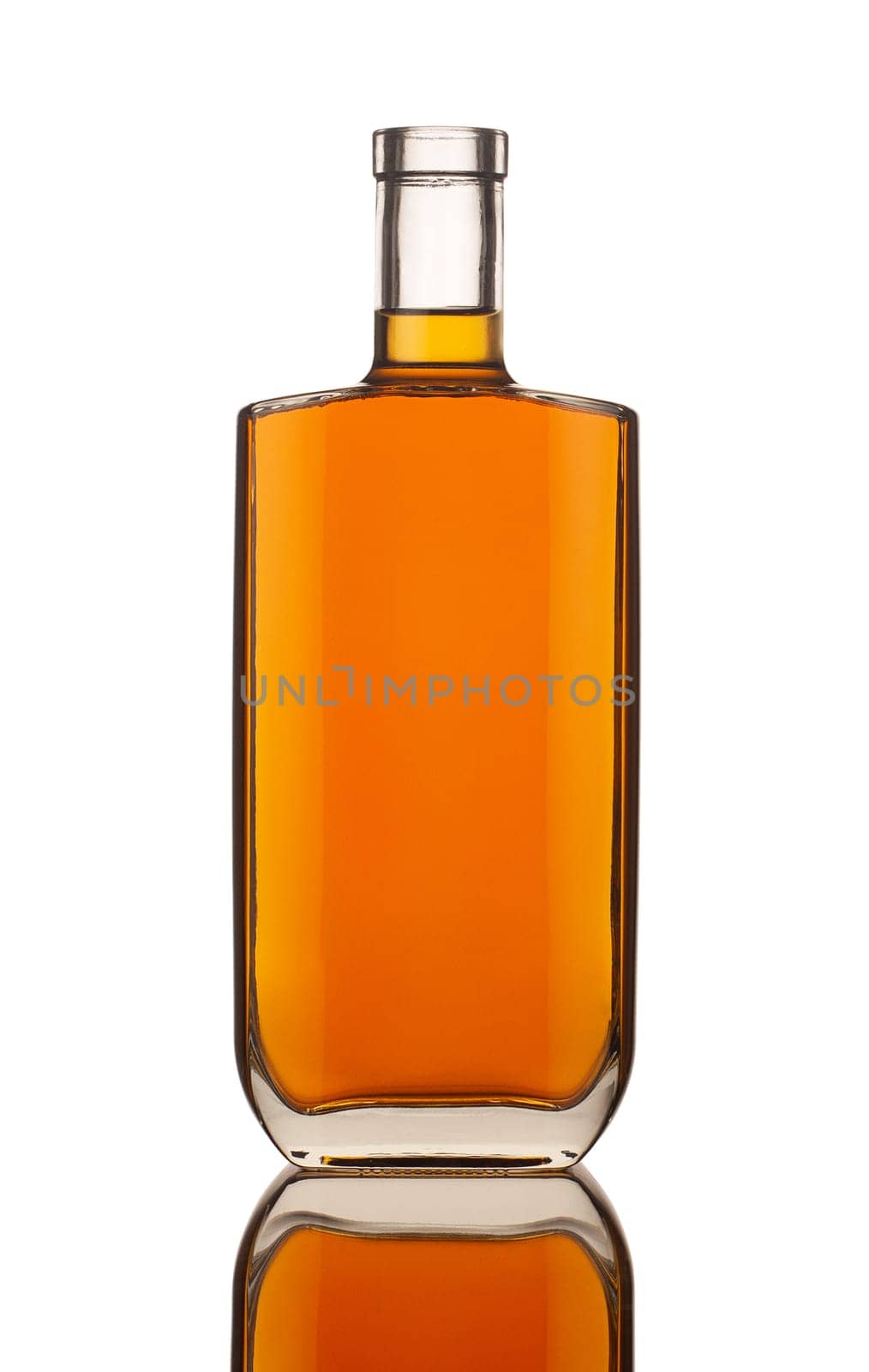 front view closeup of square modern shape cognac bottle with no label isolated on white background with reflection